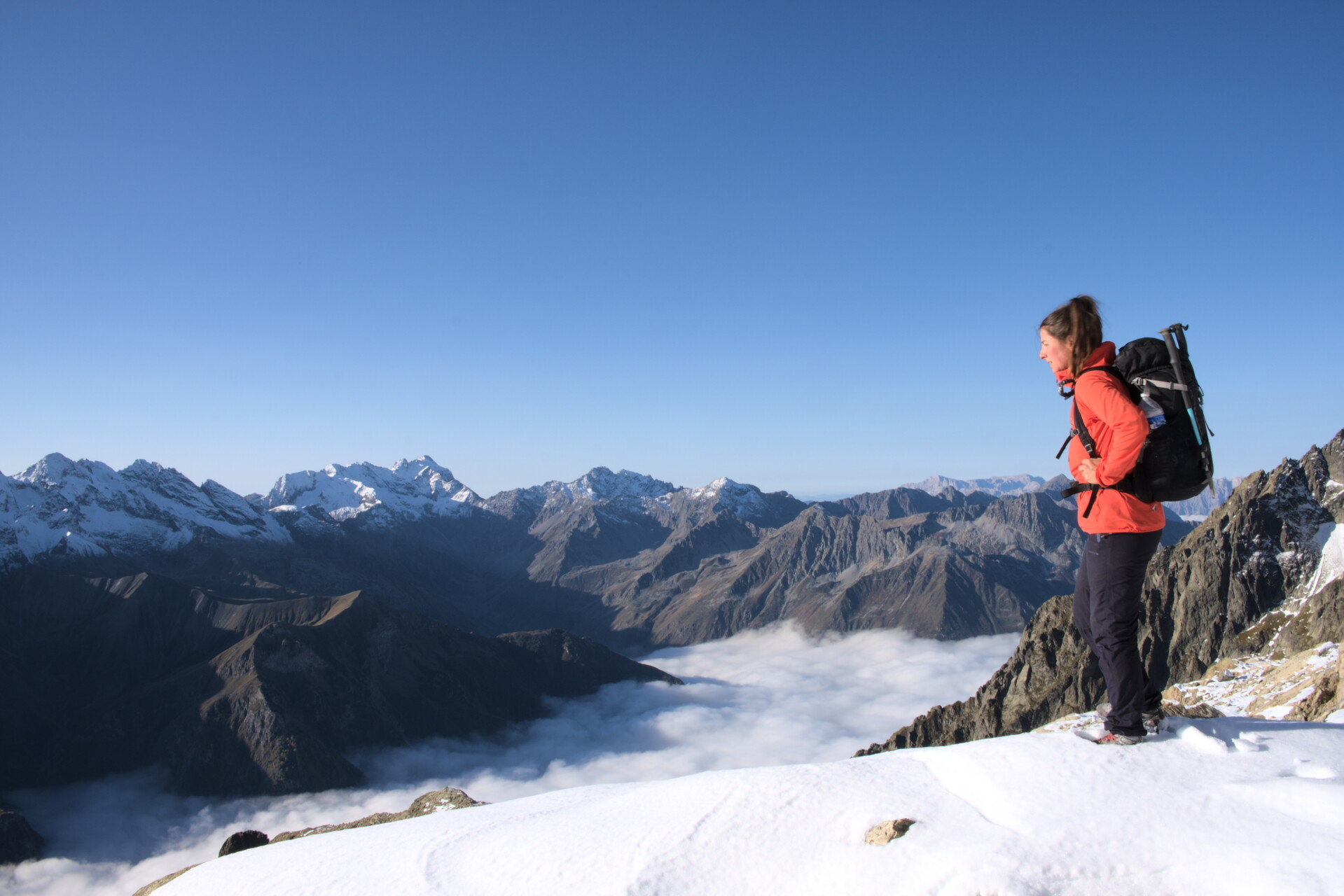 Walker on a ridge with cloud below, Valgaudemar