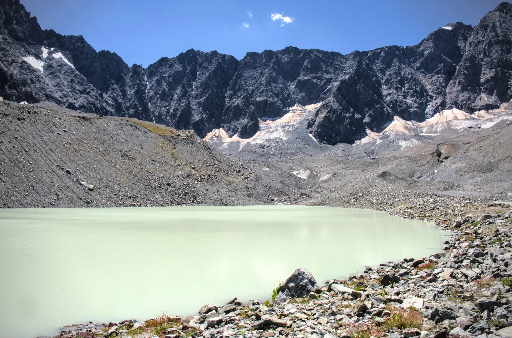 Lac du Glacier d'Arsine and its milky waters, ringed by moraines and rock walls